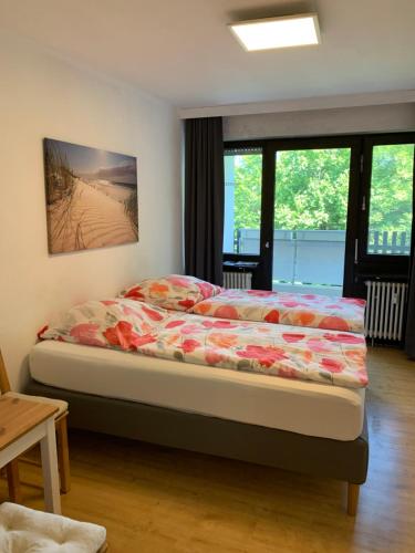 a bedroom with a bed in a room with windows at Panoramahaus 5105 in Bad Reichenhall