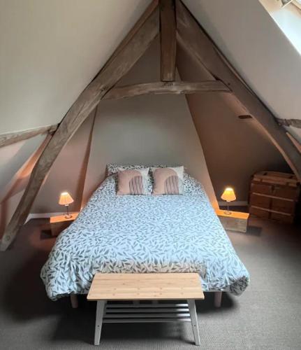 - une chambre mansardée avec un lit et 2 lampes dans l'établissement Maison de campagne, à Raye-sur-Authie