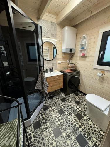 a bathroom with a shower and a sink and a toilet at Domek rekreacyjny DORAN in Tuczno