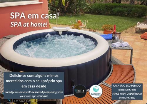 an advertisement for a spa tub in a yard at Villa Luz do Atlantico by OCvillas in Galé