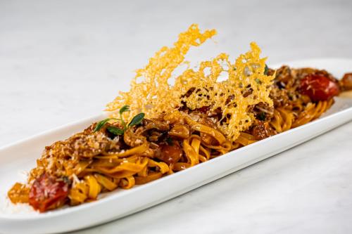 a plate of pasta on a white plate at Union Plaza Hotel in Bucharest