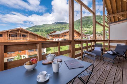 une pièce avec une table et des chaises sur un balcon dans l'établissement Megève appartement 4 pièces résidence de standing, à Megève