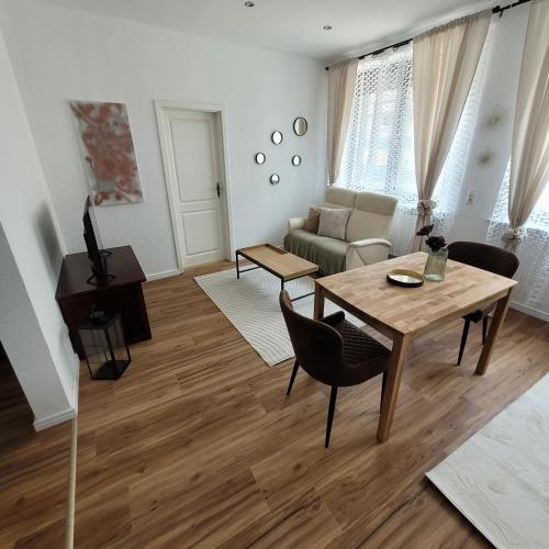 a living room with a table and a couch at Ferienwohnungen Ahrweiler in Bad Neuenahr-Ahrweiler