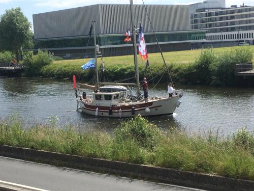 a boat in a river with flags on it at La chambre de Mathilde in Caen