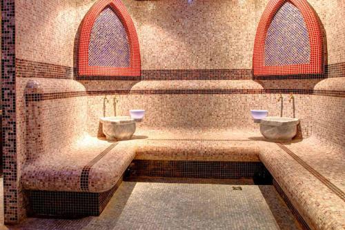 a room with two urinals on a wall at Paradise Apartments Primorsko in Primorsko