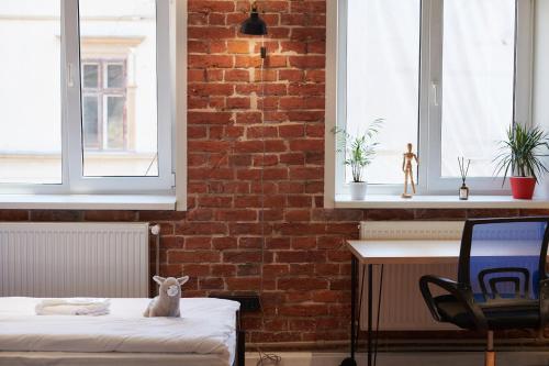 a room with a bed and a brick wall at Lama Hostel in Ivano-Frankivsʼk