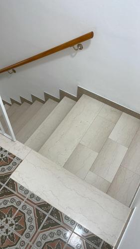 a staircase with a tile floor and a stair railing at Casa Felice in Senigallia