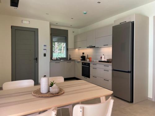 a kitchen with a wooden table and a refrigerator at Scalma Villas in Skaloma