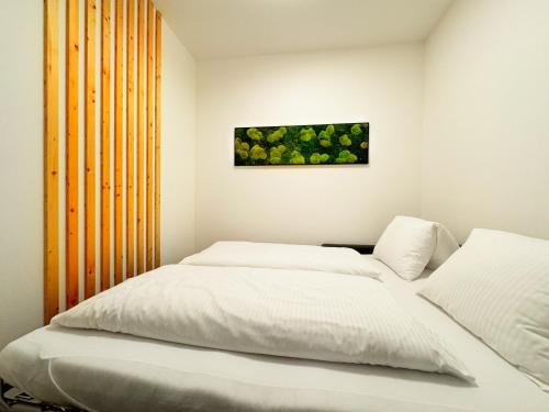 a bedroom with two beds and a painting on the wall at Lakepark Residence in Staré Splavy