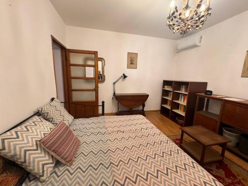 1 dormitorio con cama y lámpara de araña en Vicolo Minzoni, en Como
