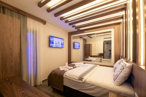 a bedroom with a bed and a large mirror at hotel di poesia deluxe in Istanbul