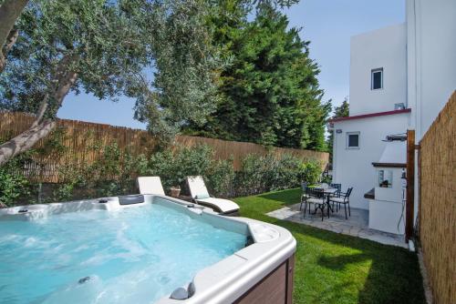 a hot tub in the yard of a backyard at Olive Spa House in Aegina Town