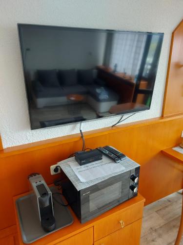 a tv on top of a table with aeper at Apartment Almberg in Mitterfirmiansreut