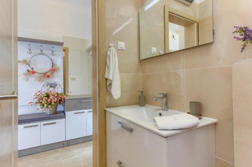 a bathroom with a sink and a mirror at Villa ARIJANA - LAVANDA in Slatine