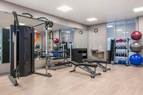 a fitness room with a gym with exercise equipment at Cambria Hotel Orlando Airport in Orlando