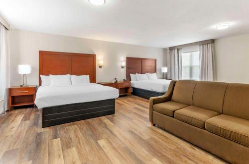 a hotel room with two beds and a couch at Comfort Inn Wytheville - Fort Chiswell in Wytheville