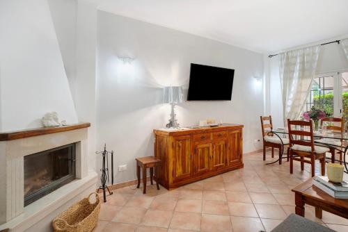 a living room with a television and a fireplace at Salice Felice in Ventimiglia