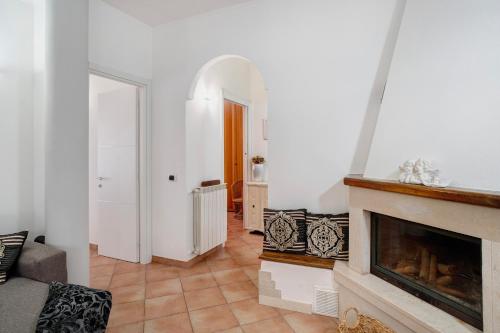 a living room with a fireplace and a hallway at Salice Felice in Ventimiglia