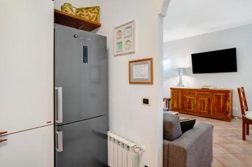 a kitchen with a refrigerator and a living room at Salice Felice in Ventimiglia