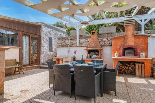 a patio with a table and an outdoor oven at La Porta Sul Mare - on the sea - Happy Rentals in Diso