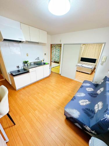 a living room with a couch and a kitchen at メゾンドリバージュ201 in Tokyo