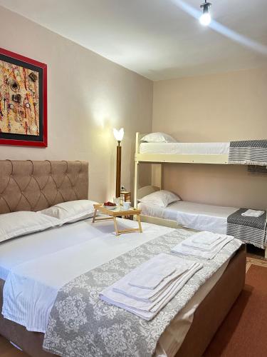 two beds in a room with two bunk beds at Vila Koltrina in Shkodër
