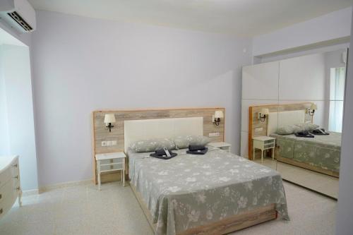 a bedroom with a bed and a large mirror at El rincón Del Prado apartamento con 4 AC in Gandía