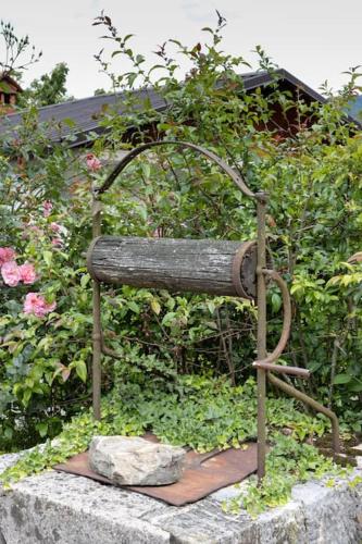 a statue of a bench sitting on a rock at Apartma na podeželju Marta- Slovenia Nature in Kanal