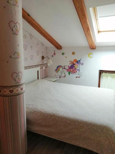 a bedroom with a large bed with butterflies on the wall at Apartma na podeželju Marta- Slovenia Nature in Kanal