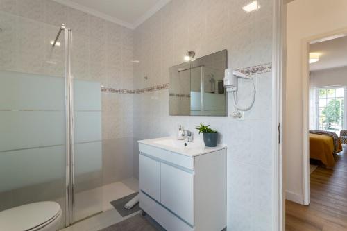 a bathroom with a toilet and a sink and a shower at Moro's Friends House - Cascais in Cascais