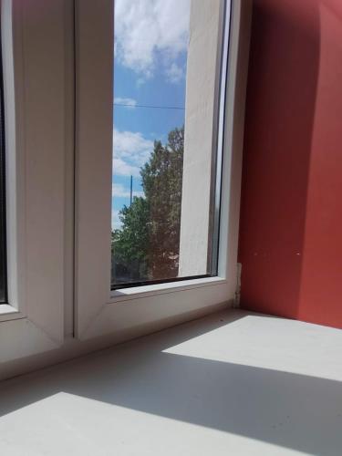 an empty room with a window with a view at Warm & Cozy apartment at Akmenu iela in Rīga