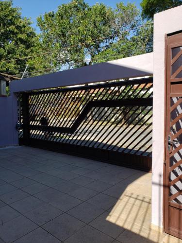 a wooden fence with a black roof on a patio at Pousada Monte Gerizim in Sao Paulo