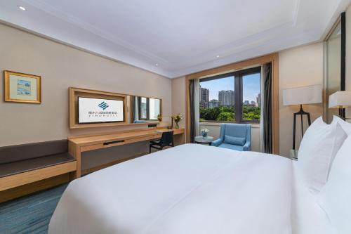 Fuzhou Bamin Yiho hotelにあるベッド