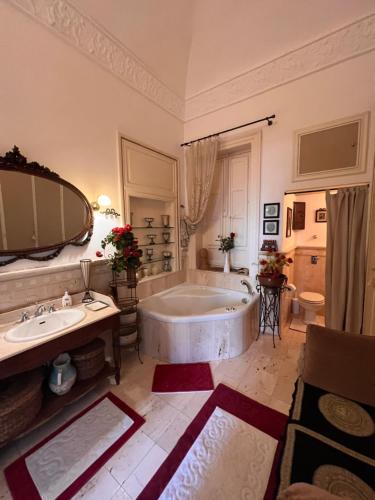 a large bathroom with a tub and a sink at Attico Vista Mare Trapani in Trapani