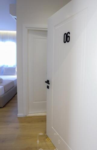 a door with the number on it in a living room at HM Boutique Hotel in Krujë