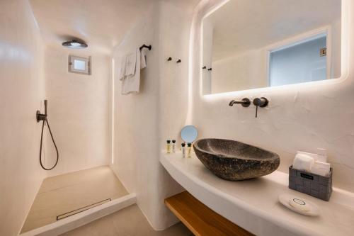 a bathroom with a sink and a mirror at Athina Luxury Suites in Fira