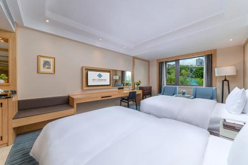 Fuzhou Bamin Yiho hotelにあるベッド