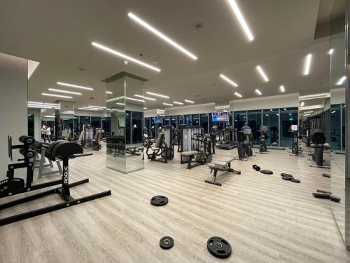 a gym with several treadmills and machines in a building at GuestReady - Sweet Escape in Dubai