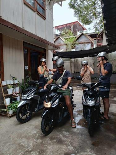 a group of men are sitting on motorcycles at MyGuide Travellers Inn in Coron