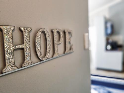 a sign that says love on a wall at Winterton Country Lodge @ Rose Cottage in Winterton
