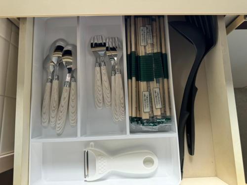 a cupboard with many utensils in it at プレストスクエア松島町 in Takamatsu