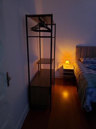 a room with a bed and a shelf next to a bed at Pousada Monte Gerizim in Sao Paulo