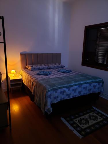 a bedroom with a large bed in a room at Pousada Monte Gerizim in Sao Paulo