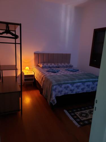 a bedroom with a large bed and a mirror at Pousada Monte Gerizim in Sao Paulo