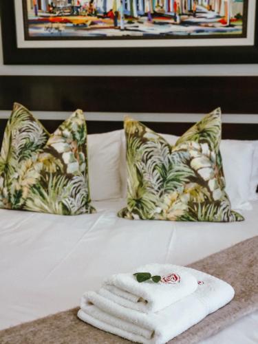 a hotel room with a bed with towels on it at Winterton Country Lodge @ Rose Cottage in Winterton