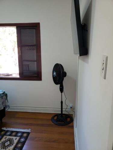 a room with a fan in a room with a window at Pousada Monte Gerizim in Sao Paulo