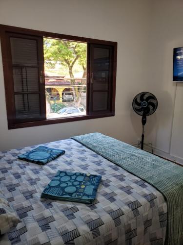 a bedroom with a bed with two trays on it at Pousada Monte Gerizim in Sao Paulo