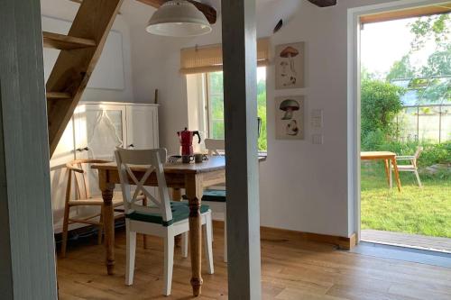a kitchen and dining room with a table and chairs at Wildlife-Chalet auf unserer Farm in Tyringe