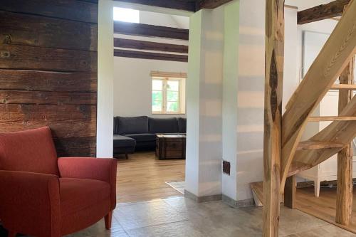 a living room with a red chair and a couch at Wildlife-Chalet auf unserer Farm in Tyringe