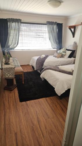 a bedroom with two beds and a window at Cosy haven in Harrismith